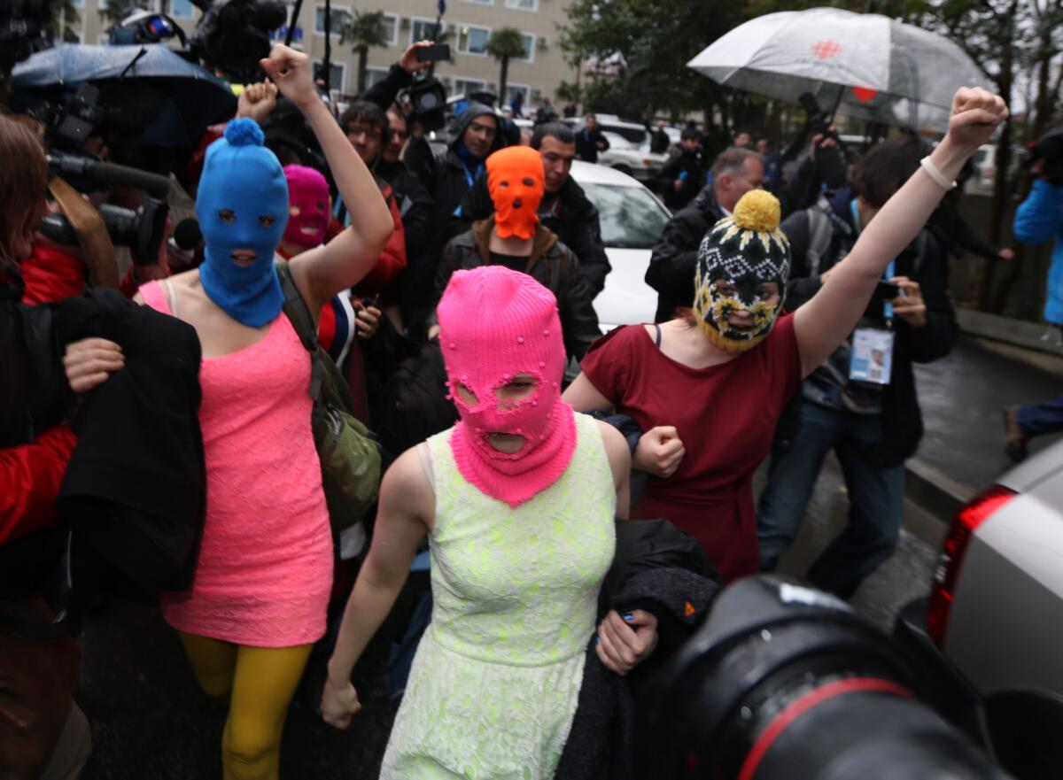 Pussy Riot members march in the streets of Sochi, Russia, upon their release from a police station Tuesday.