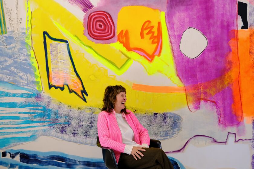 Artist Monique van Genderen with one of her large-scale canvases.  