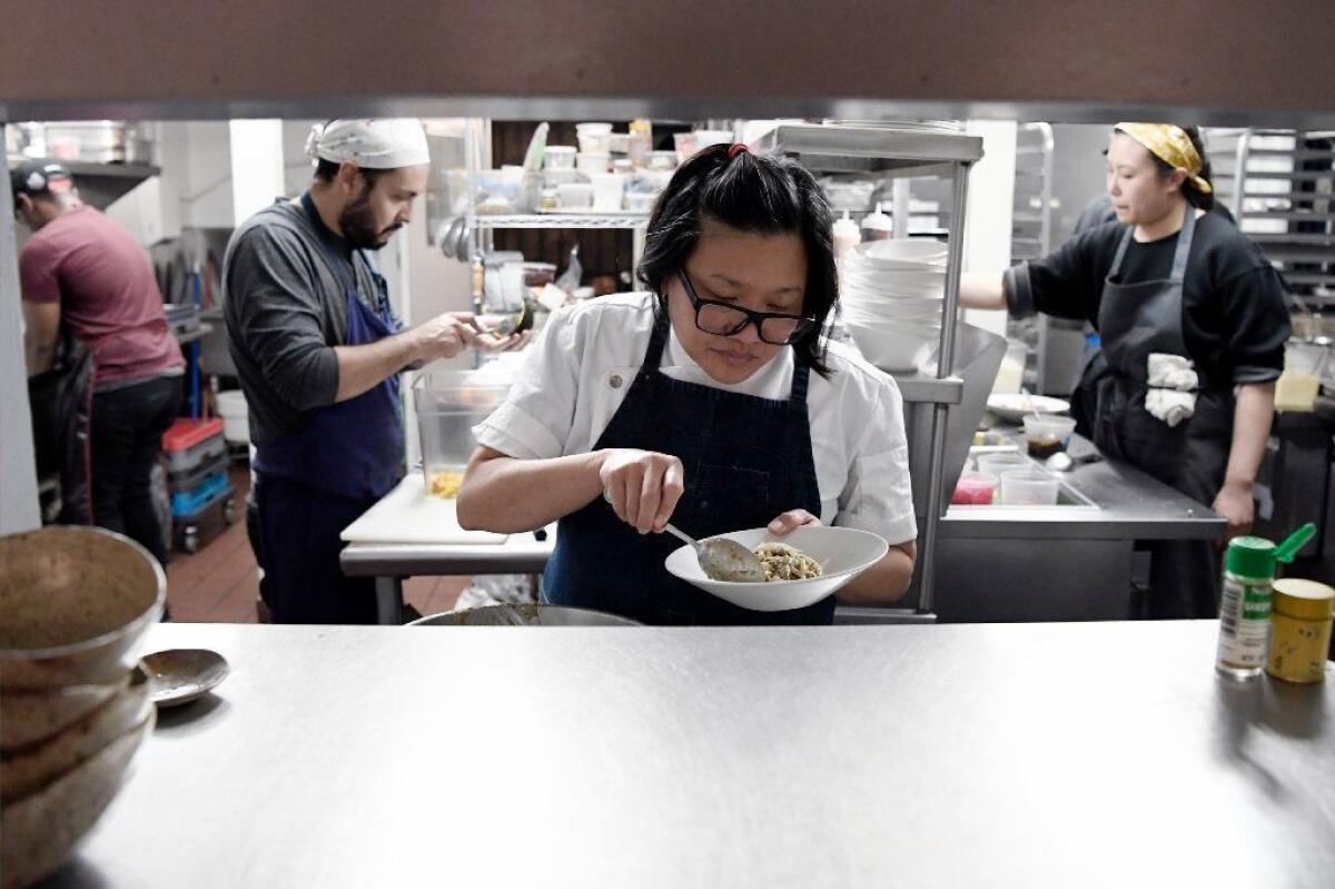 Chef-owner Minh Phan in Porridge + Puffs' kitchen window.