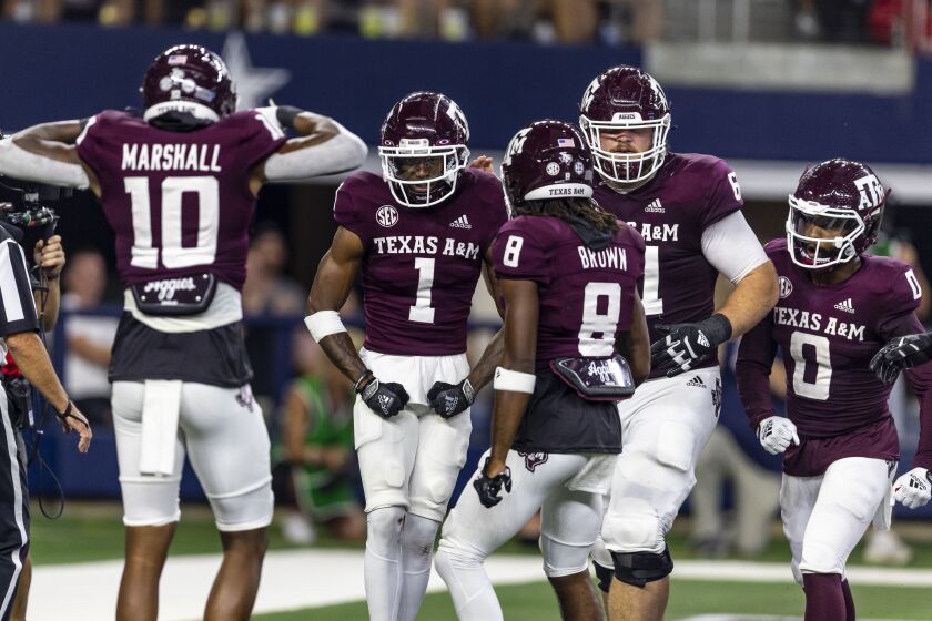 Texas A&M wide receiver Evan Stewart (1) celebrates his touchdown against Arkansas with teammates during the first half of an NCAA college football game Saturday, Sept. 24, 2022, in Arlington, Texas. (AP Photo/Brandon Wade)