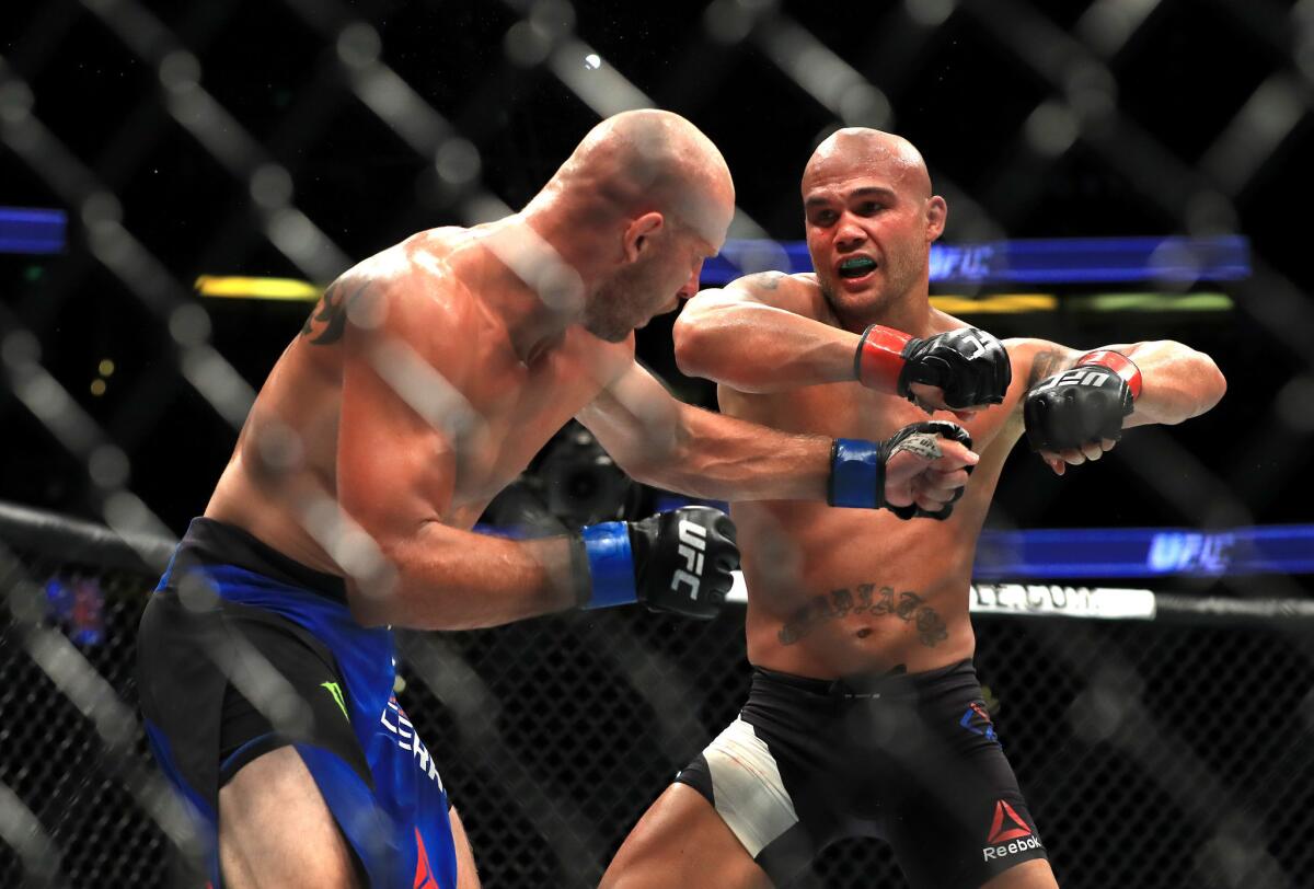 Robbie Lawler, right, goes on the offensive against Donald Cerrone during their welterweight bout at UFC 214 on July 29.