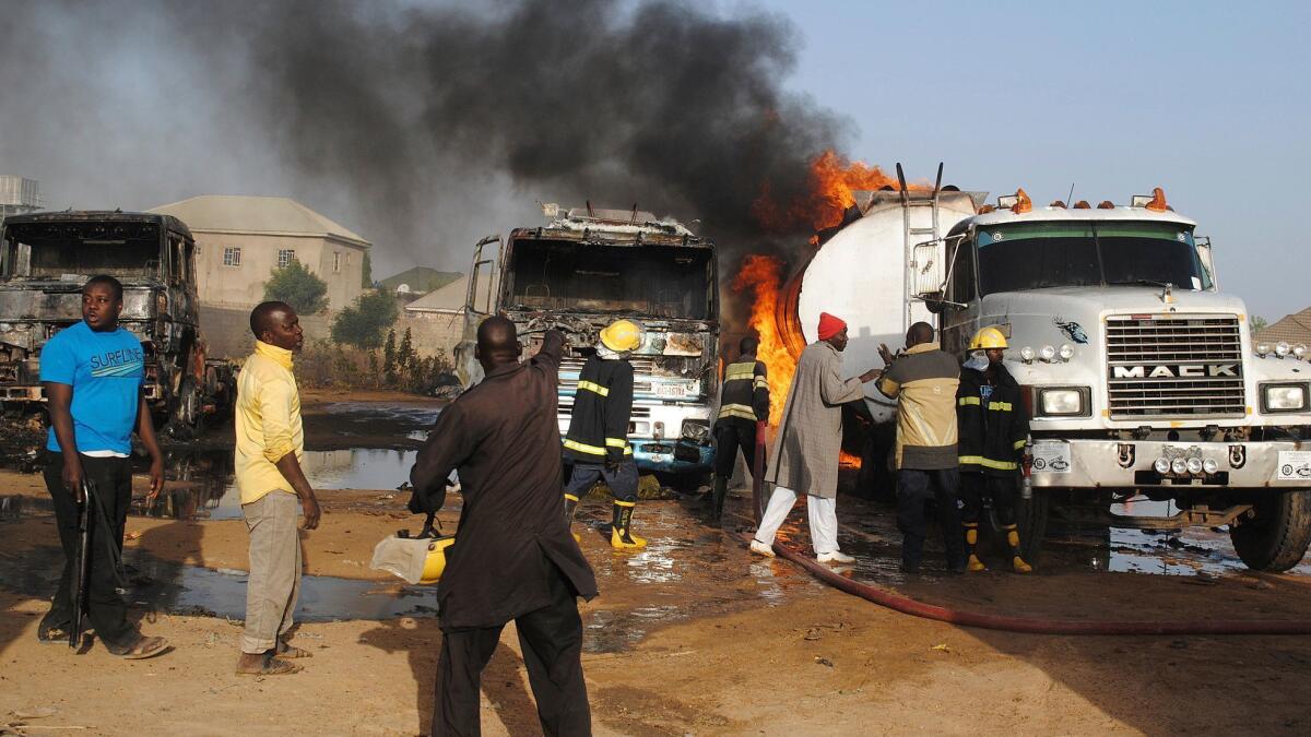 Firefighters try to contain a fire following a suicide attack at petrol tankers in Maiduguri, Nigeria, Friday, March. 3, 2017.