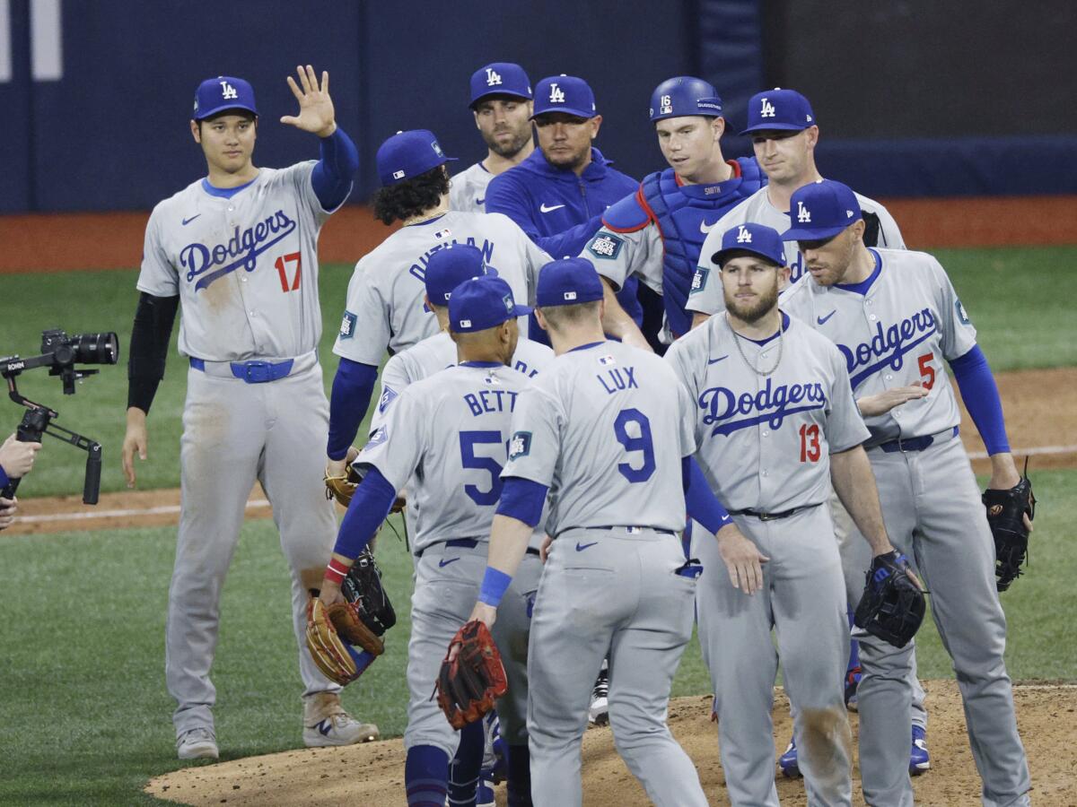 Los Angeles Dodgers celebrate following their 5-2 win over the San Diego Padres in the season opener in Seoul, South Korea.