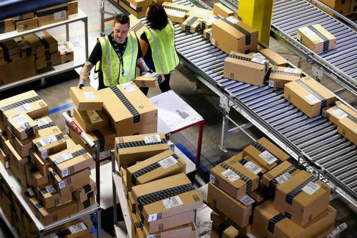 Amazon employees organize packages at one of the company's fulfillment centers.