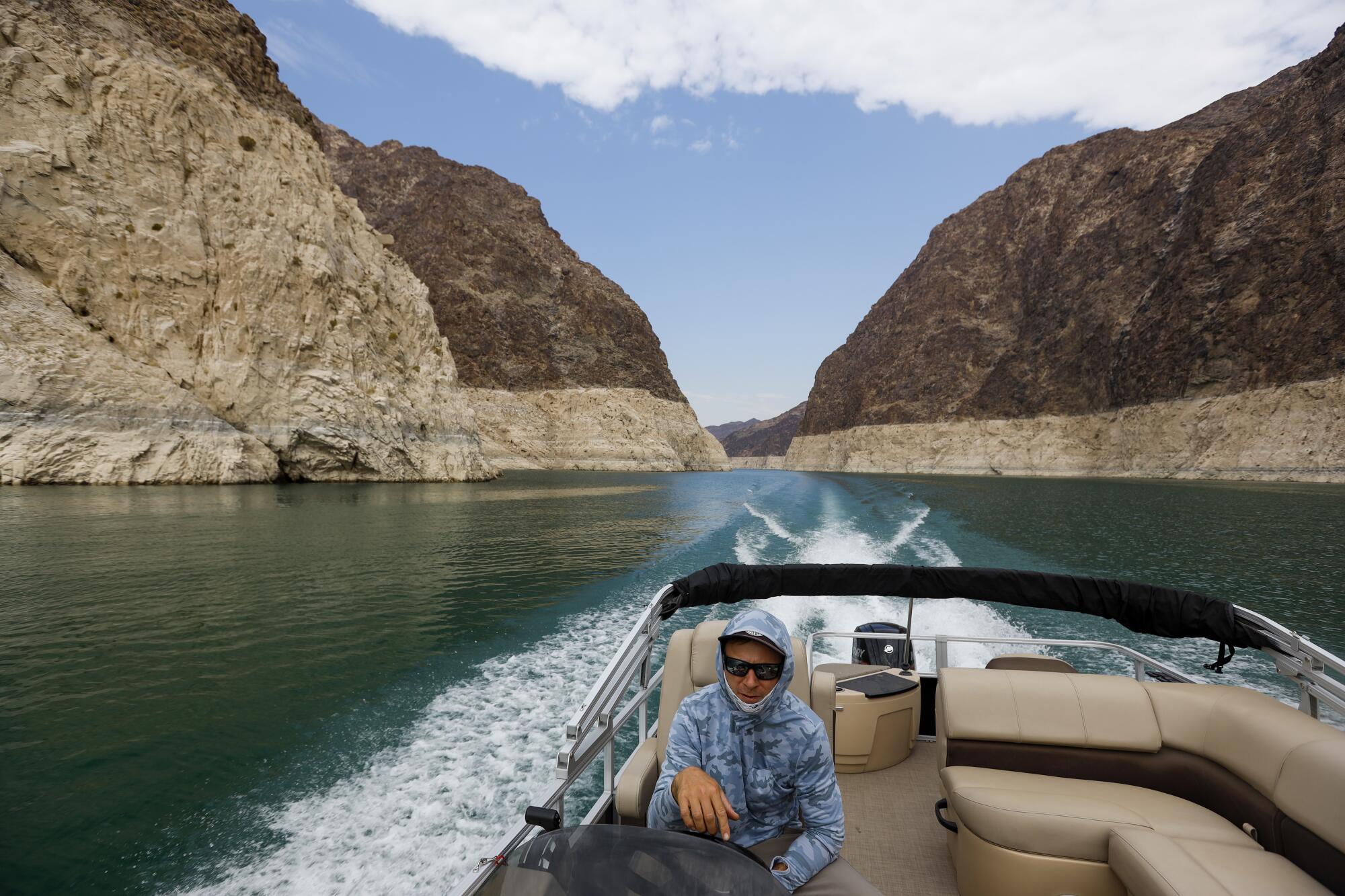 Eric Richins pilots a boat on Lake Mead