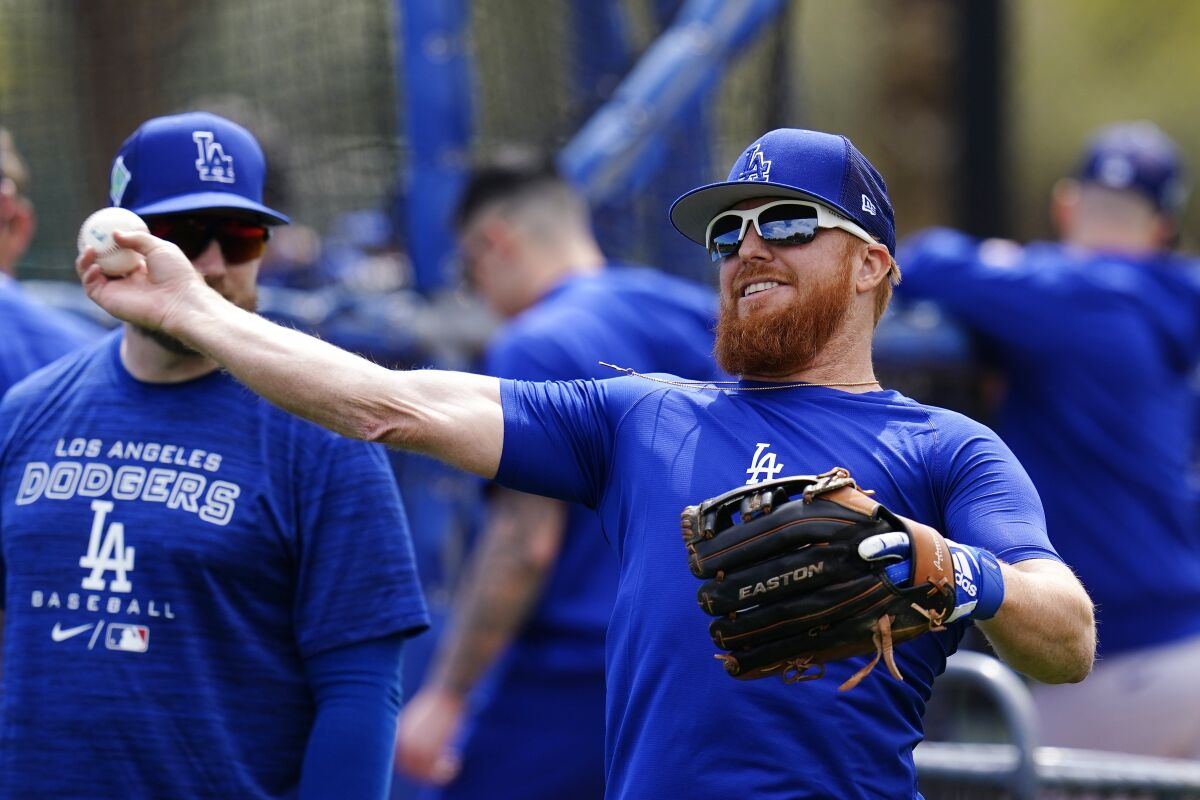 Los Angeles Dodgers third baseman Justin Turner warms up during a spring training baseball workout 