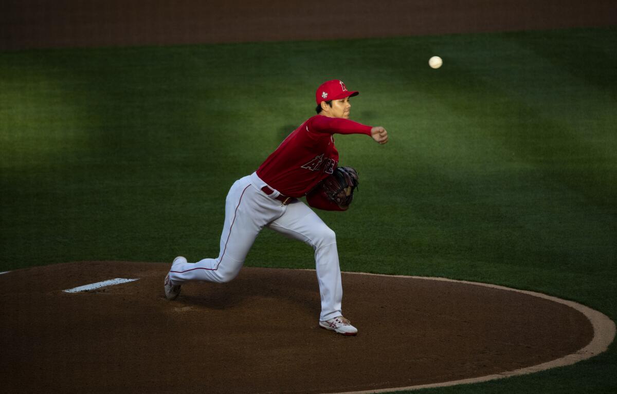 The Angels' Shohei Ohtani throws to the plate.