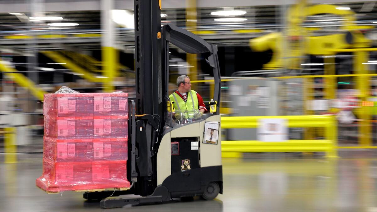 A forklift operator moves a pallet of goods at an Amazon.com fulfillment center in DuPont, Wash.