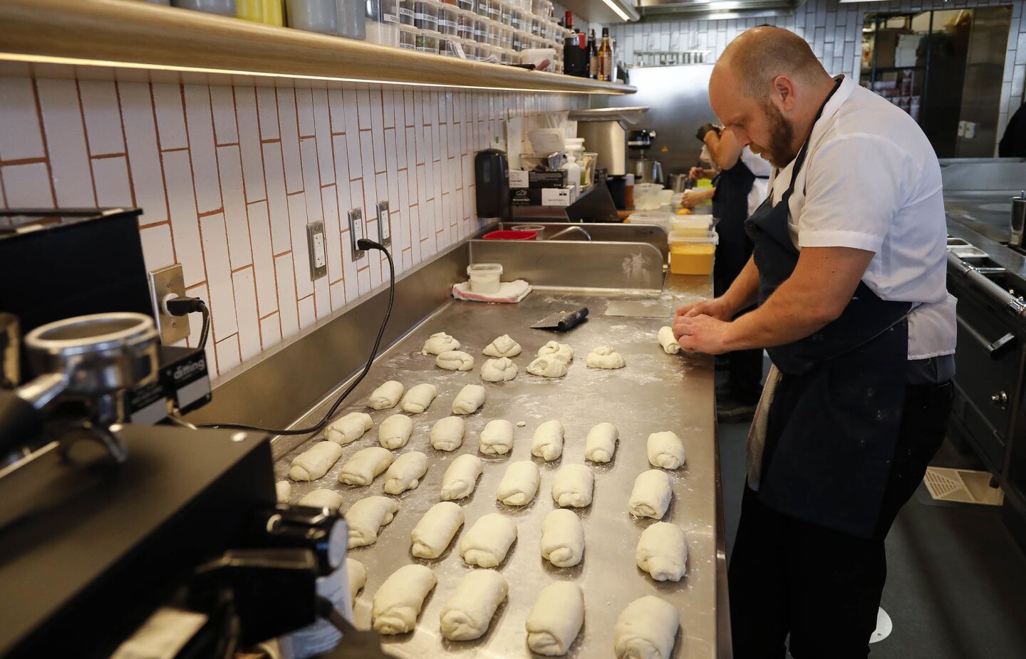 Joe Bell prepares sourdough baguettes at Jeune et Jolie restaurant, which opened Dec. 15 in Carlsbad. The nouvelle French restaurant has an ambitious French pastry program.