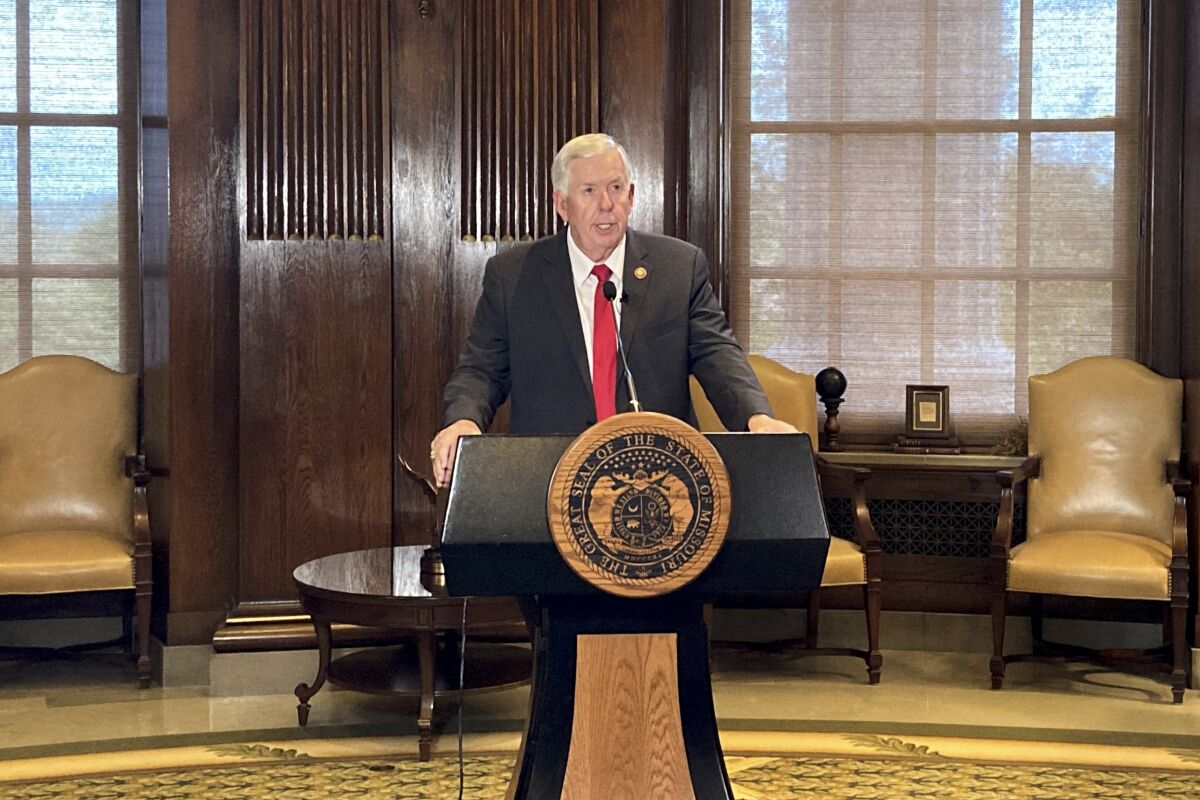 Missouri Gov. Mike Parson speaks from a lectern before signing legislation cutting the state’s income tax rate on Wednesday, Oct. 5, 2022, at his Capitol office in Jefferson City, Mo. Parson said the new law would cut people’s taxes by 5% and cost the state about $760 million when fully phased in over several years. (AP Photo/David A. Lieb)