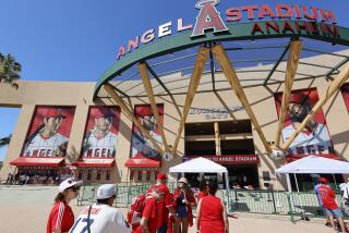 Anaheim, CA - July 21: Angels starting pitcher, two-way player and designated hitter Shohei Ohtani's image (at left) looms large over fans waiting to get in to see the Angels play the Pirates at Angel Stadium in Anaheim Friday, July 21, 2023. (Allen J. Schaben / Los Angeles Times)
