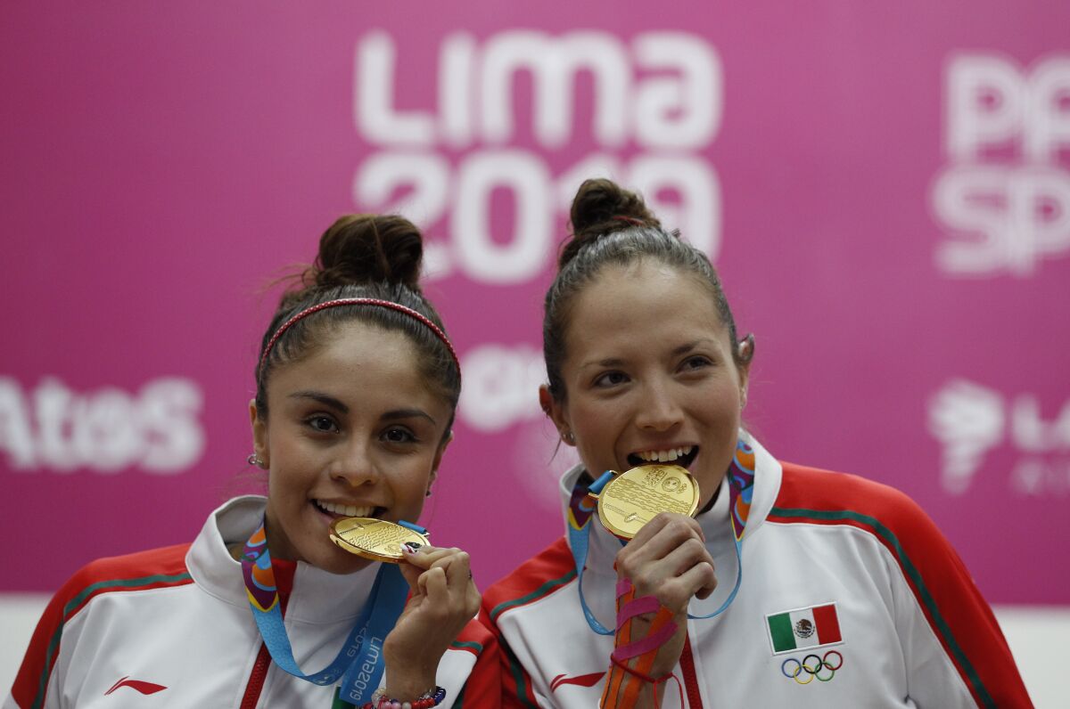 Mexico's Paola Longoria, left, and Samantha Salas pose with their gold medals for women's team racquetball at the Pan American Games in Lima, Peru, Wednesday, Aug. 7, 2019. (AP Photo/Rebecca Blackwell)