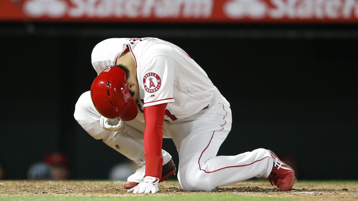 Shohei Ohtani reacts after being hit on the finger by a fastball as he struck out in the eighth inning of Monday's loss to the Minnesota Twins at Angel Stadium.