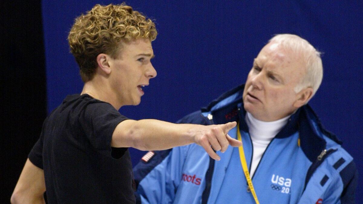 Frank Carroll coaches Tim Goebel during practice for the 2002 Winter Olympics in Salt Lake City.