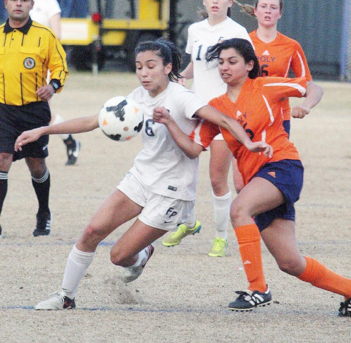 Flintridge Prep's Julia Gonzalez battles Pasadena Poly's Alex Treister in a Prep League girls' soccer game at Flintridge Prep.