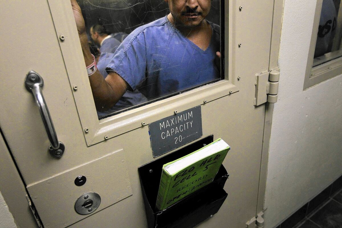 An immigrant in a holding cell at a U.S. Immigration and Customs Enforcement detention facility.