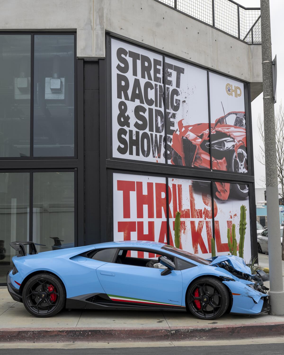A wrecked powder blue Lamborghini staged on Melrose Avenue
