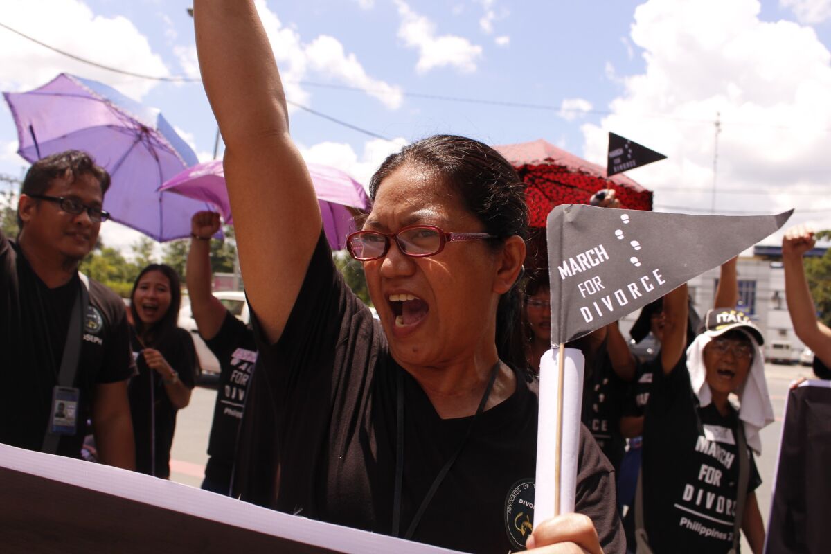 Lu Mercado raises her fists at a rally in Manila on Aug. 3, 2016, demanding legalization of divorce in the Philippines.