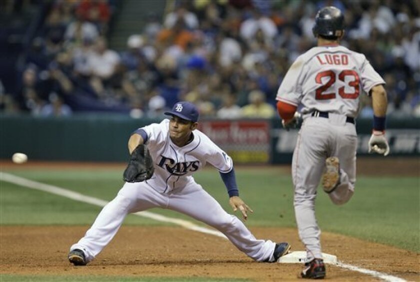 In this July 2, 2008, file photo, Tampa Bay Rays first baseman Carlos Pena, left, prepares to catch the ball and make the out on Boston Red Sox's Julio Lugo during a Major League Baseball game in St. Petersburg, Fla. Pena raised his profile Thursday when he won the American League Gold Glove award at first base for the first time in his career. (AP Photo/Chris O'Meara, File)