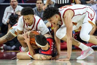 Los Angeles, CA, Tuesday, March 1, 2022 - USC Trojans guard Boogie Ellis (0) and USC Trojans forward Max Agbonkpolo (23) wrestle for the ball with Arizona Wildcats guard Kerr Kriisa (25) at the Galen Center. (Robert Gauthier/Los Angeles Times)