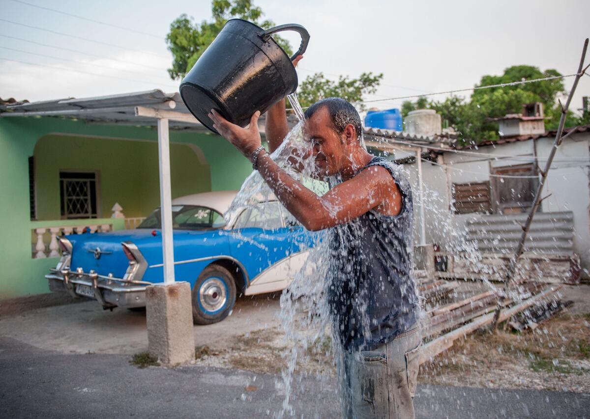 A Cuban man refreshes himself during a summer heat wave in Havana last month.