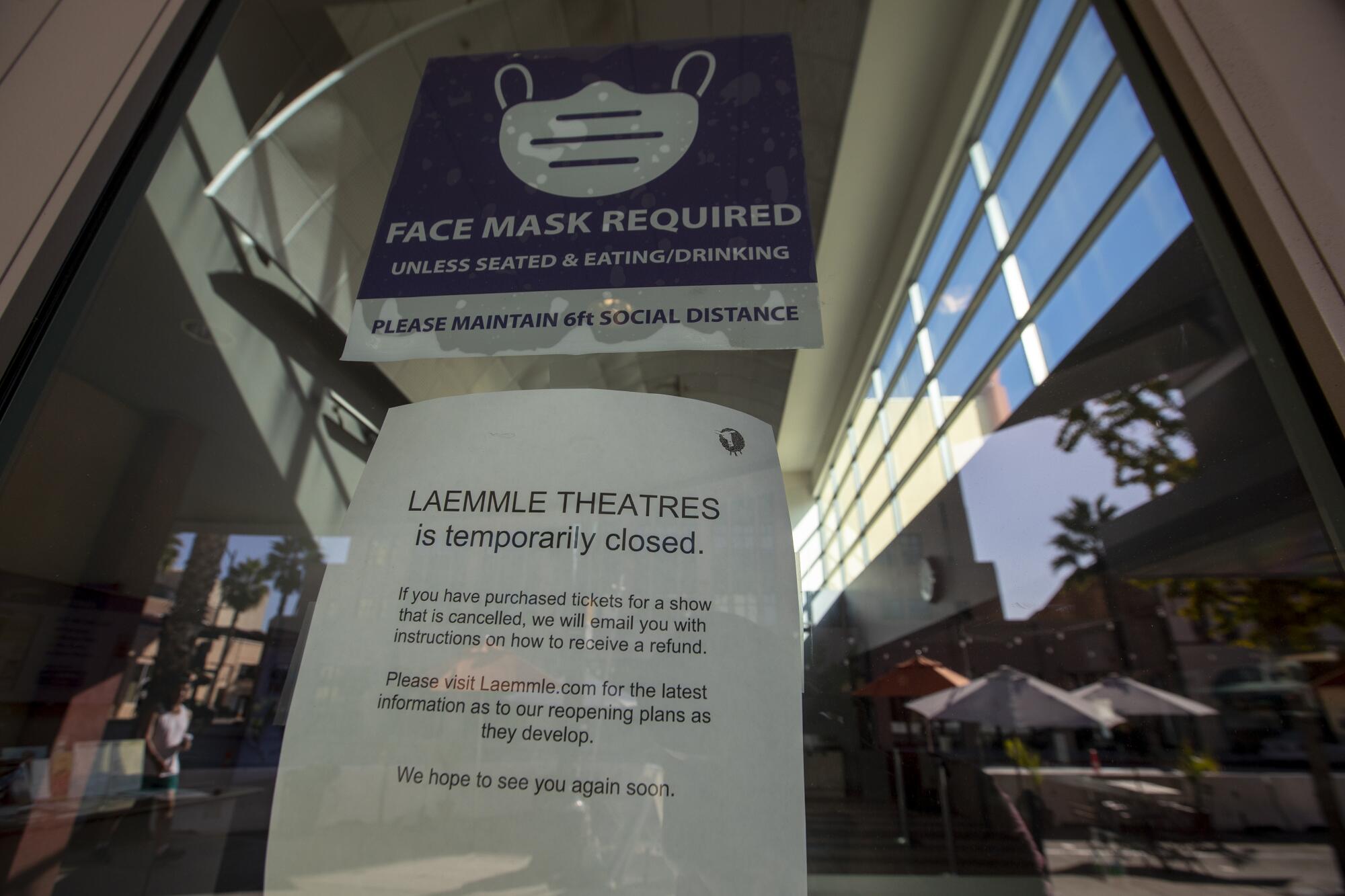 A "closed" sign is posted on the Laemmle theater on Colorado Boulevard in Pasadena.