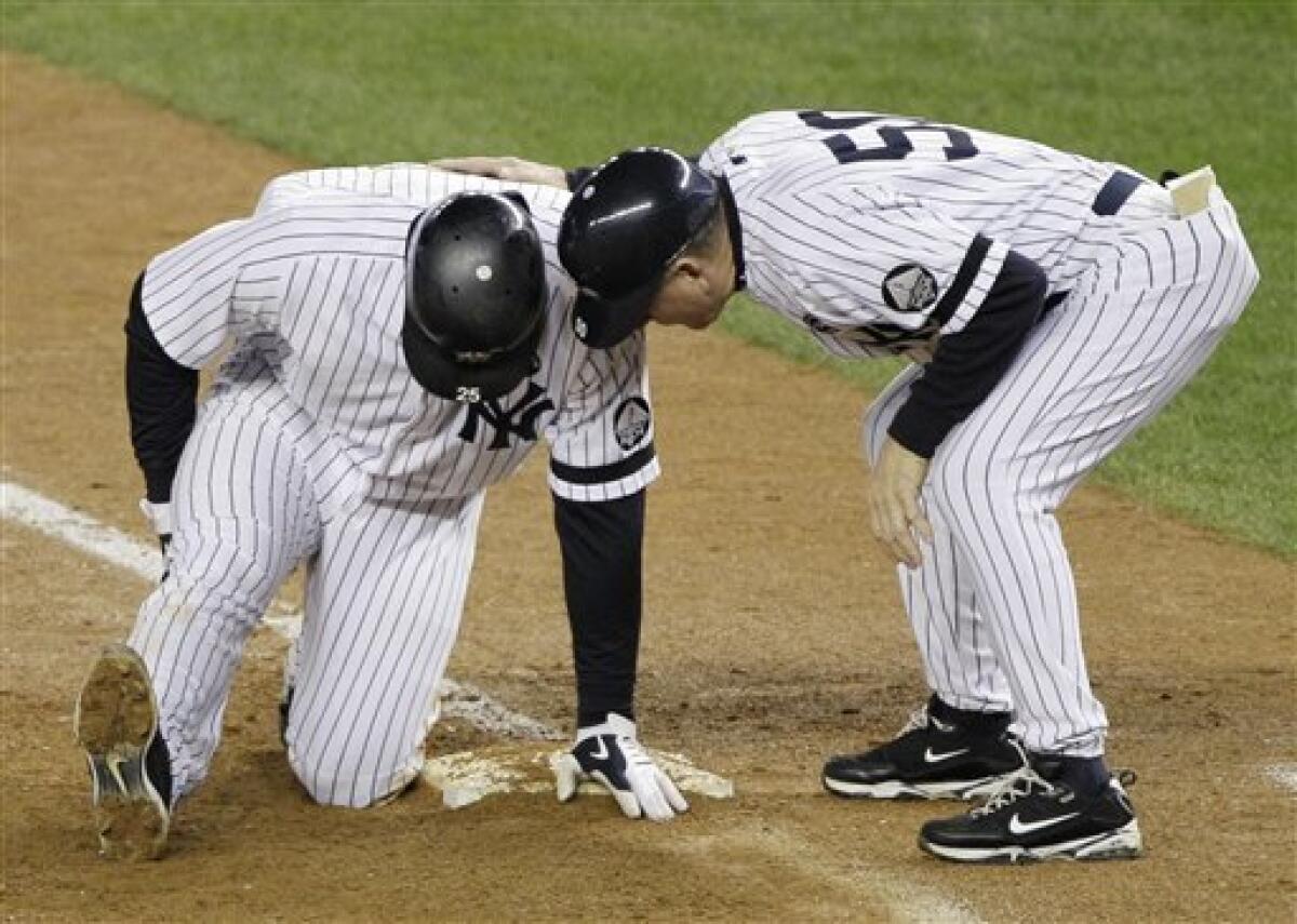 New York Yankees' Lance Berkman rips off his shirt during batting