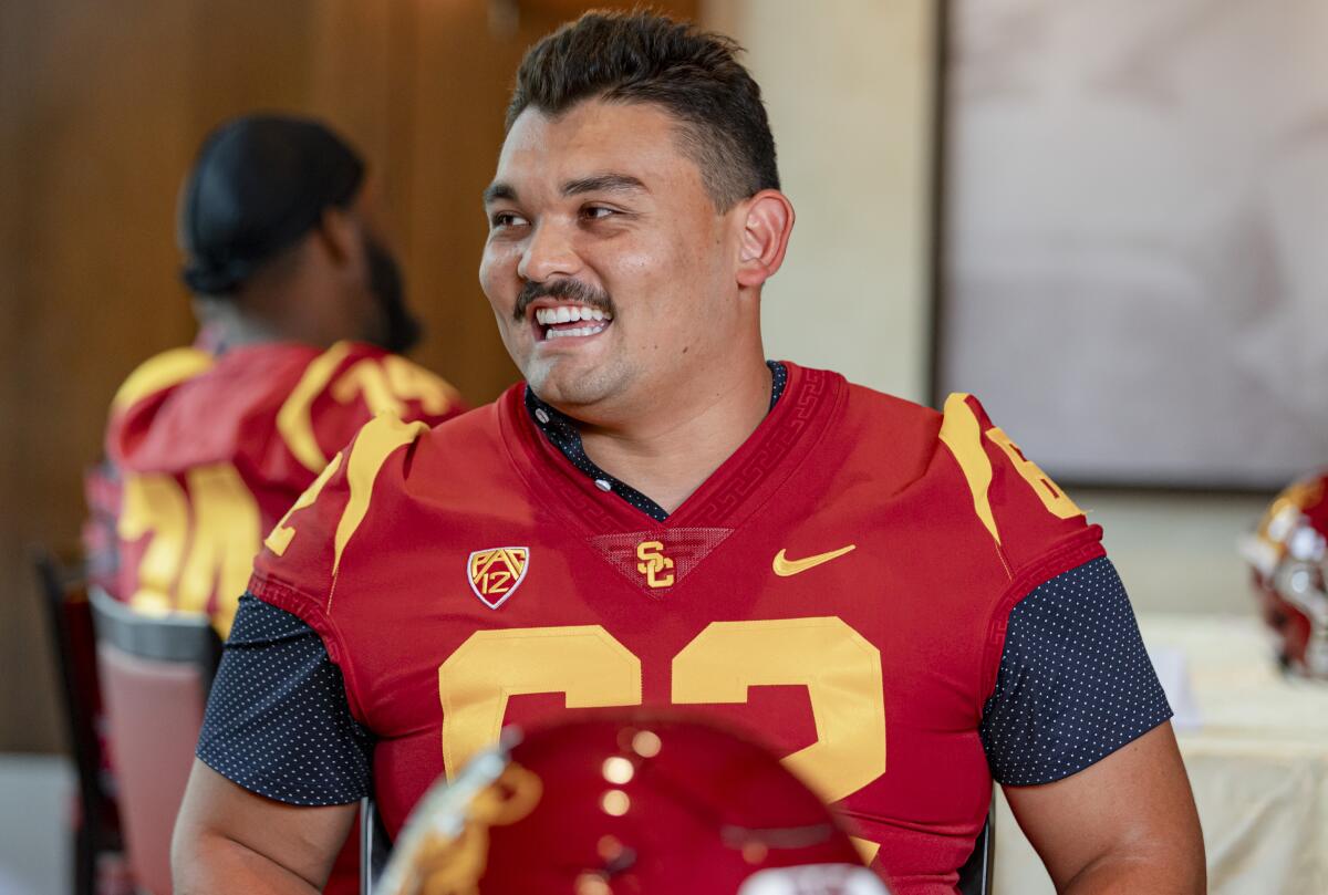 USC offensive lineman Brett Neilon talks with reporters during media day