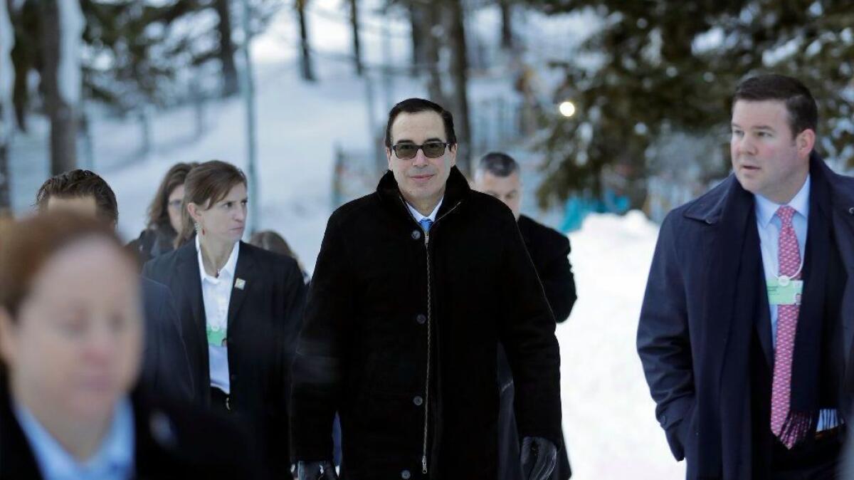 Treasury Secretary Steven T. Mnuchin walks through the snow at the World Economic Forum in Davos, Switzerland, on Wednesday.