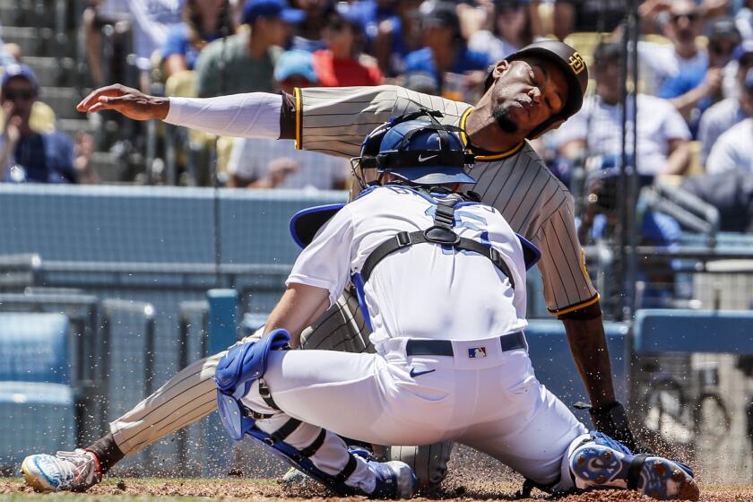 Los Angeles, CA, Sunday, July 3, 2022 - San Diego Padres right fielder Jose Azocar (28) is tagged out by Los Angeles Dodgers catcher Austin Barnes (15) on a fielders choice grounder hit by Manny Machado in the third inning at Dodger Stadium. (Robert Gauthier/Los Angeles Times)