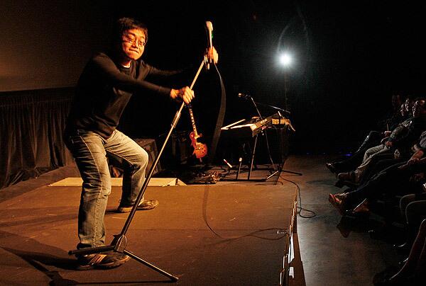 Stand-up comic Joe Wong performs at a club in downtown Los Angeles. The Chinese-born Wong, 41, worked as a biomedical researcher before embarking on a comedy career full time. At first, audiences couldn't understand his English. See full story