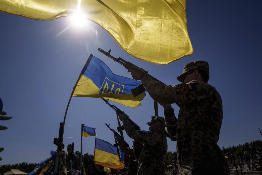 Honor guards shoot into the air during the funeral ceremony of six Ukrainian servicemen killed in a Russian rocket attack at a Ukrainian military academy, during their funeral ceremony in Poltava, Ukraine, Saturday Sept. 7, 2024. (AP Photo/Evgeniy Maloletka)