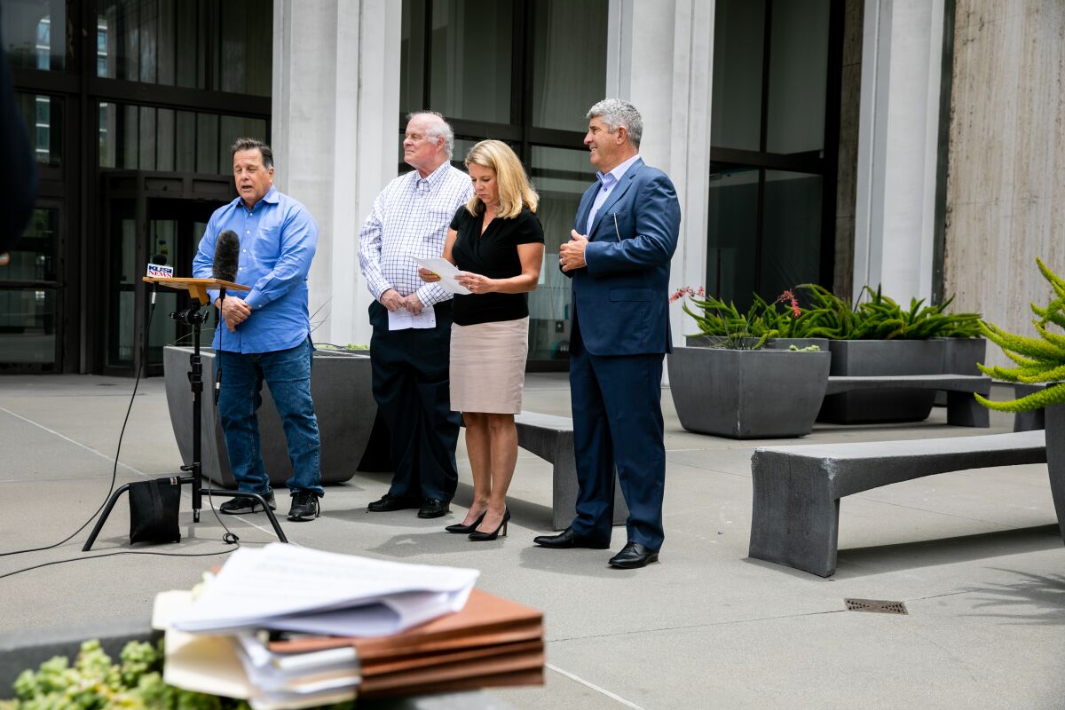 Former San Diego City Attorney Michael Aguirre, left, spoke at a press conference in June in downtown San Diego.