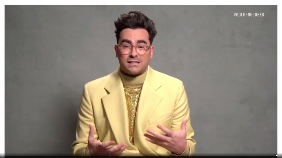 Dan Levy in a blazer and turtleneck