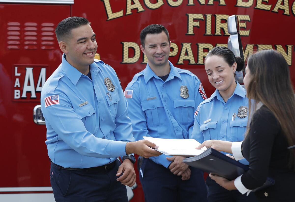 EMTs receive certificates from U.S. Rep. Michelle Steele's office during a ceremony for the new in-house ambulance program.