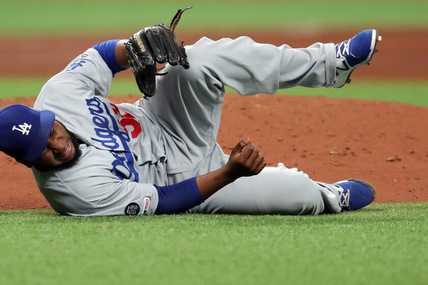 ST. PETERSBURG, FL - MAY 21: Pedro Baez #52 of the Los Angeles Dodgers reacts after being hit by a line drive off the bat of Willy Adames of the Tampa Bay Rays in the seventh inning at Tropicana Field on May 21, 2019 in St. Petersburg, Florida. (Photo by Mike Carlson/Getty Images) ** OUTS - ELSENT, FPG, CM - OUTS * NM, PH, VA if sourced by CT, LA or MoD **