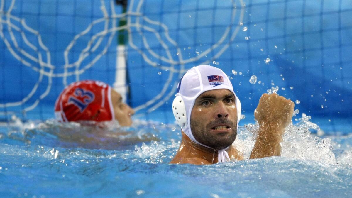 USA's Ryan Bailey celebrates a US goal against Serbia goalkeeper Slobodan Soro during water polo semifinal at the Yingdong Natatorium at Summer Olympics in Beijing, China on Aug. 22, 2008.