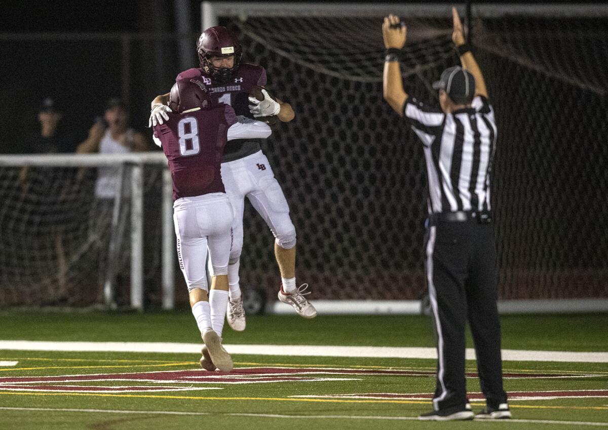 Laguna Beach's Aidan Moss, left, celebrates a touchdown with Nick Rogers during a nonleague game against Northwood.