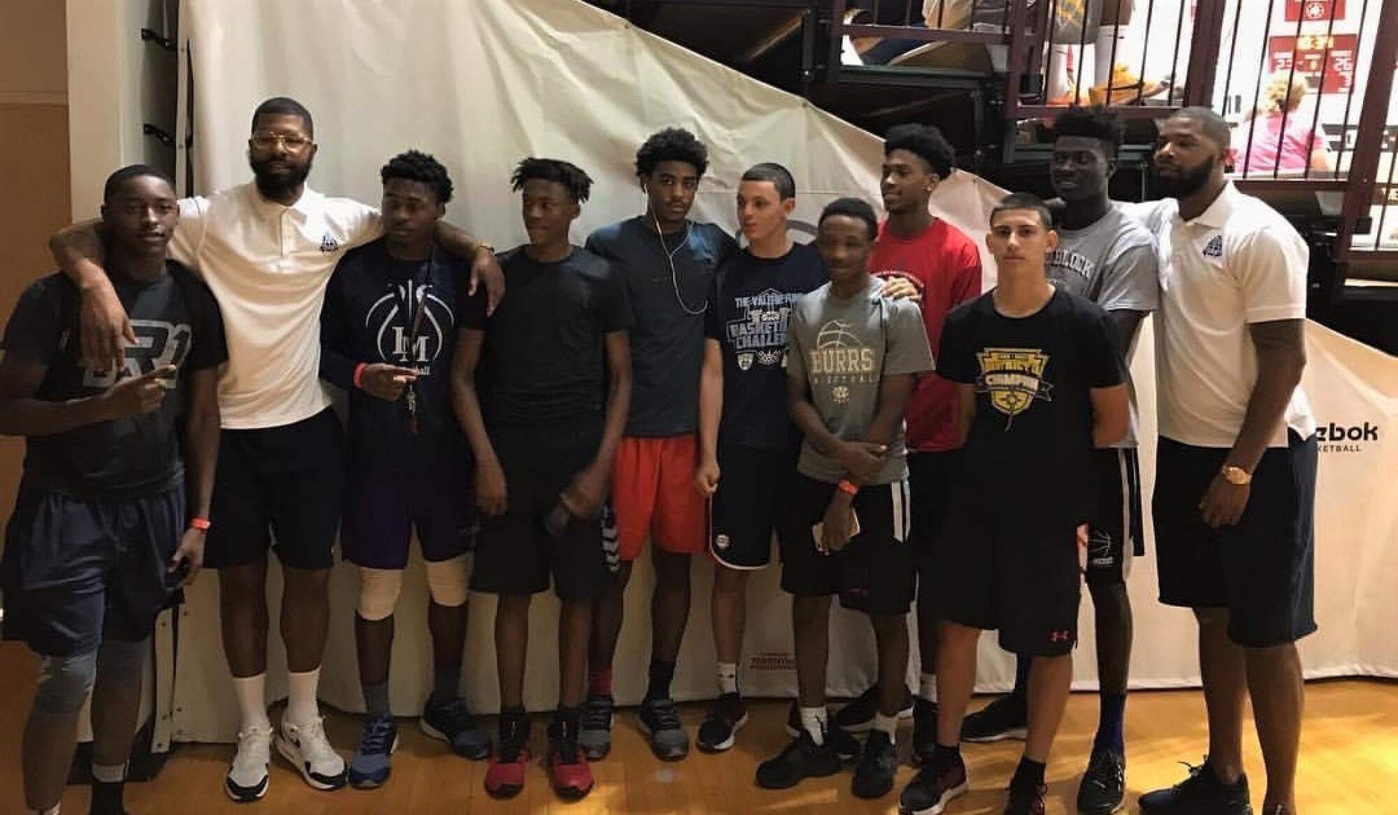 Marcus Morris Sr. (far right) poses for a photo with an AAU team that featured Bones Hyland (fourth from left).