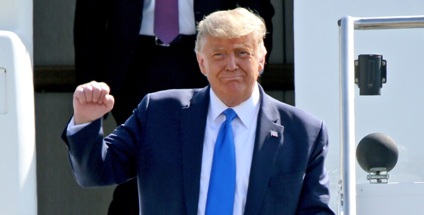 President Donald Trump clenches and raises his right.
