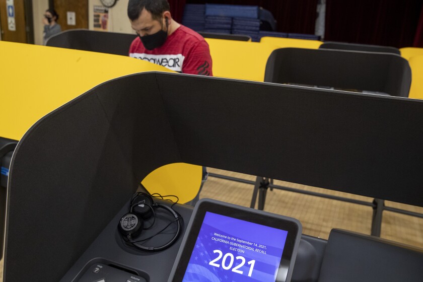 A voter casts his ballot Tuesday at the Boyle Heights Senior Center.