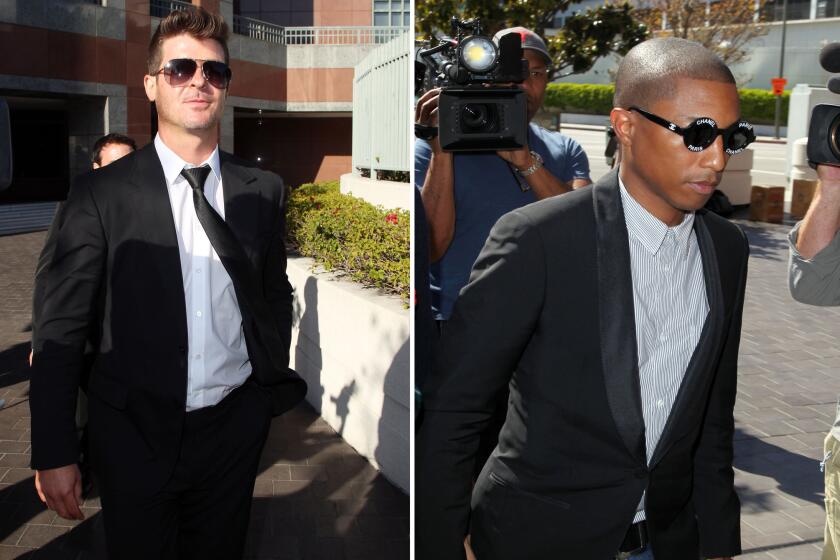 Musicians Robin Thicke, left, and Pharrell Williams are seen outside the federal courthouse in Los Angeles on March 5.