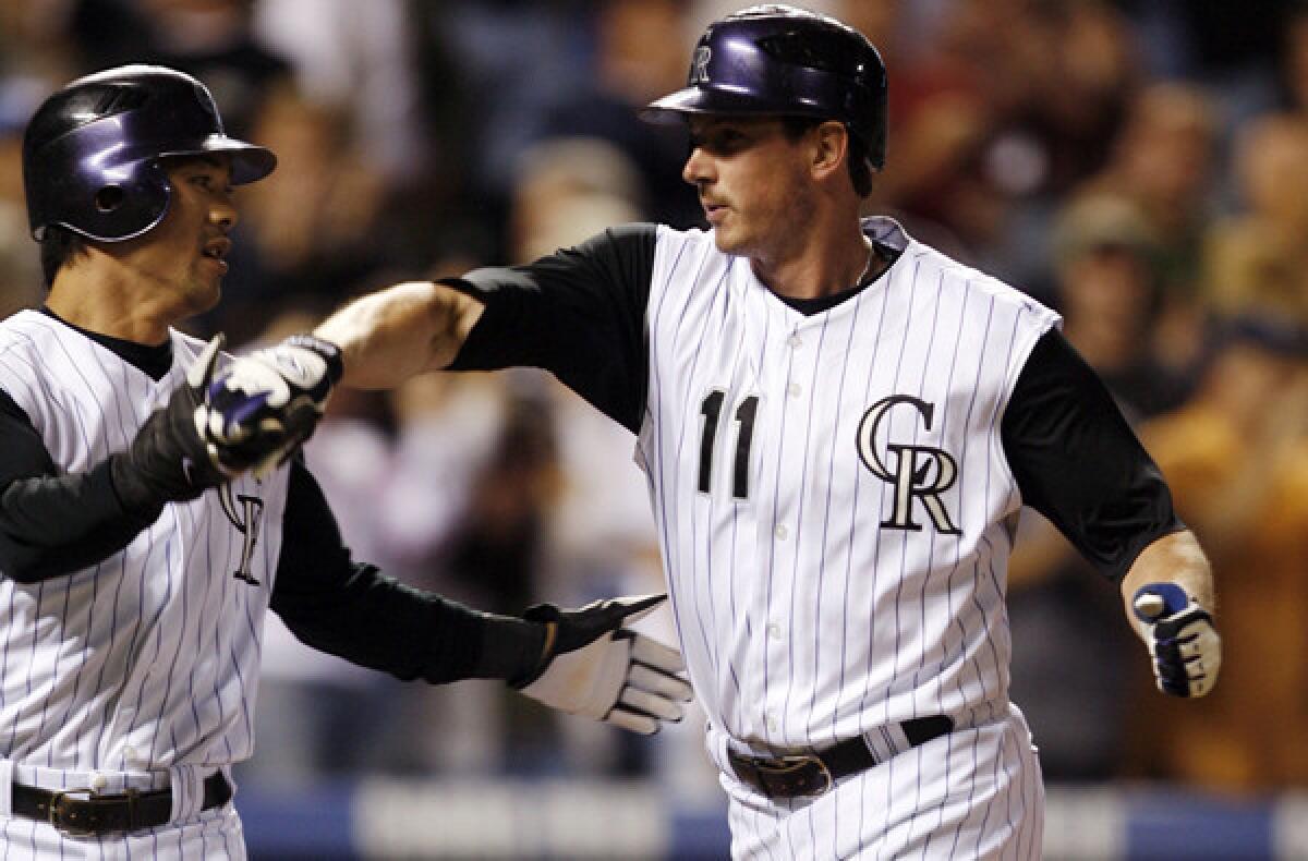 Brad Hawpe (11) is congratulated by then-Rockies teammate Kazuo Matsui after hitting a two-run home run against the Dodgers in 2007.