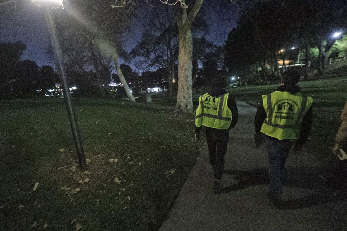 Volunteers Josh Lord and Josh Fryday, both from Gov. Gavin Newsom's office, walk in Brace Canyon Park in Burbank looking for homeless people on Tuesday as part of the Greater Los Angeles Homeless Count. 