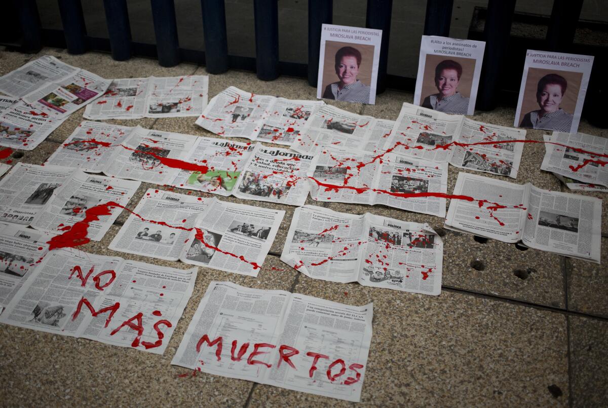 A message that reads in Spanish "No More Deaths" is written in red paint on newspapers