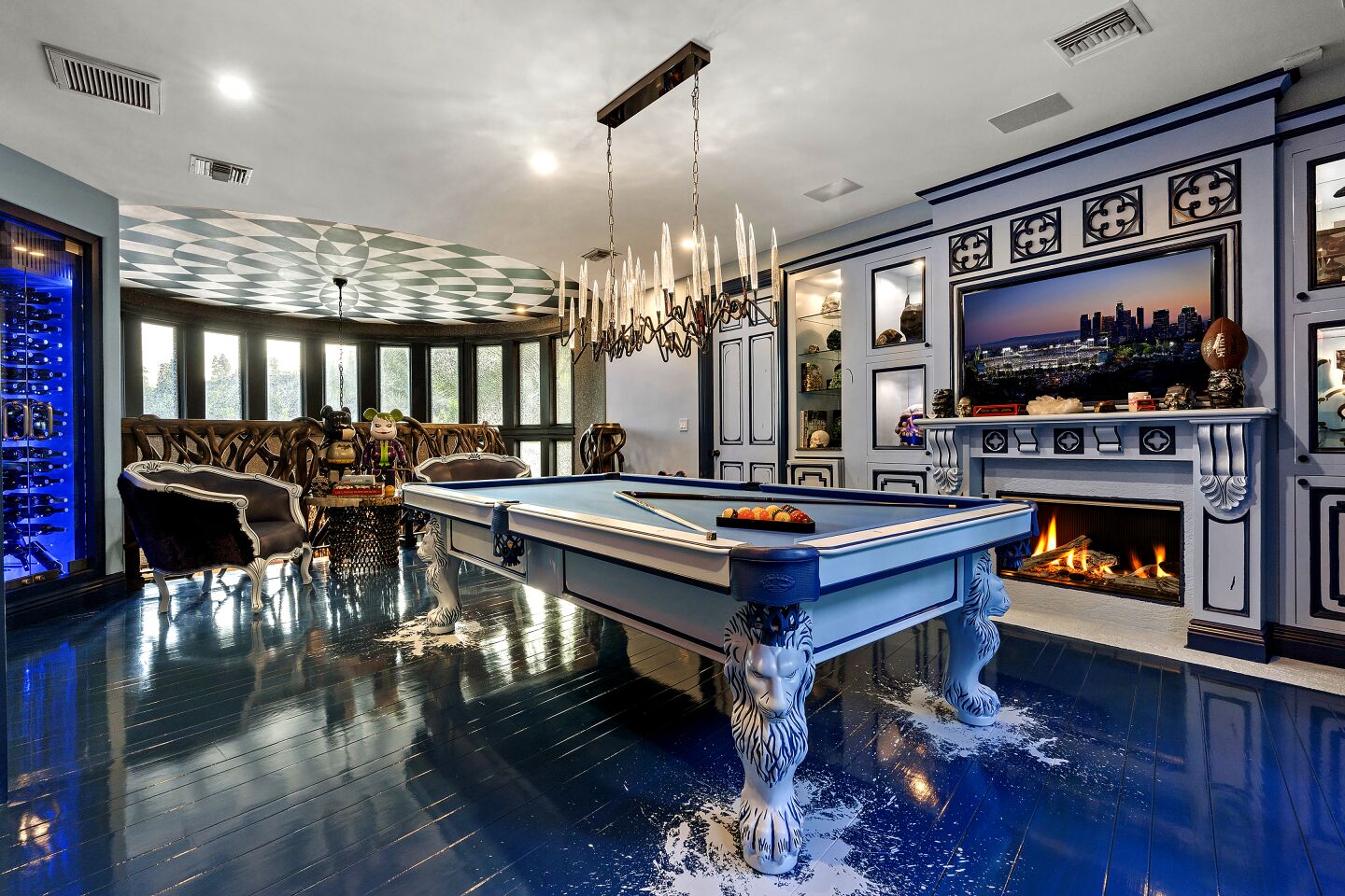 Beverages are close at hand in the billiards room, which has splashes of white paint on the floor.