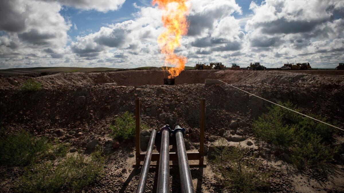 With oil prices and production surging and regional gas prices in a tailspin, Texas is considering whether to loosen its restrictions on burning off excess gas that is pumped up with oil.