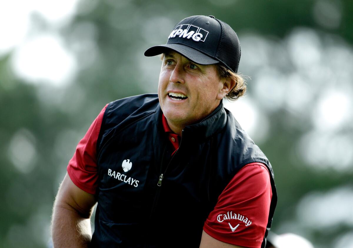 Phil Mickelson watches his tee shot at the 11th hole during the first round of the Wells Fargo Championship on Thursday at Quail Hollow.