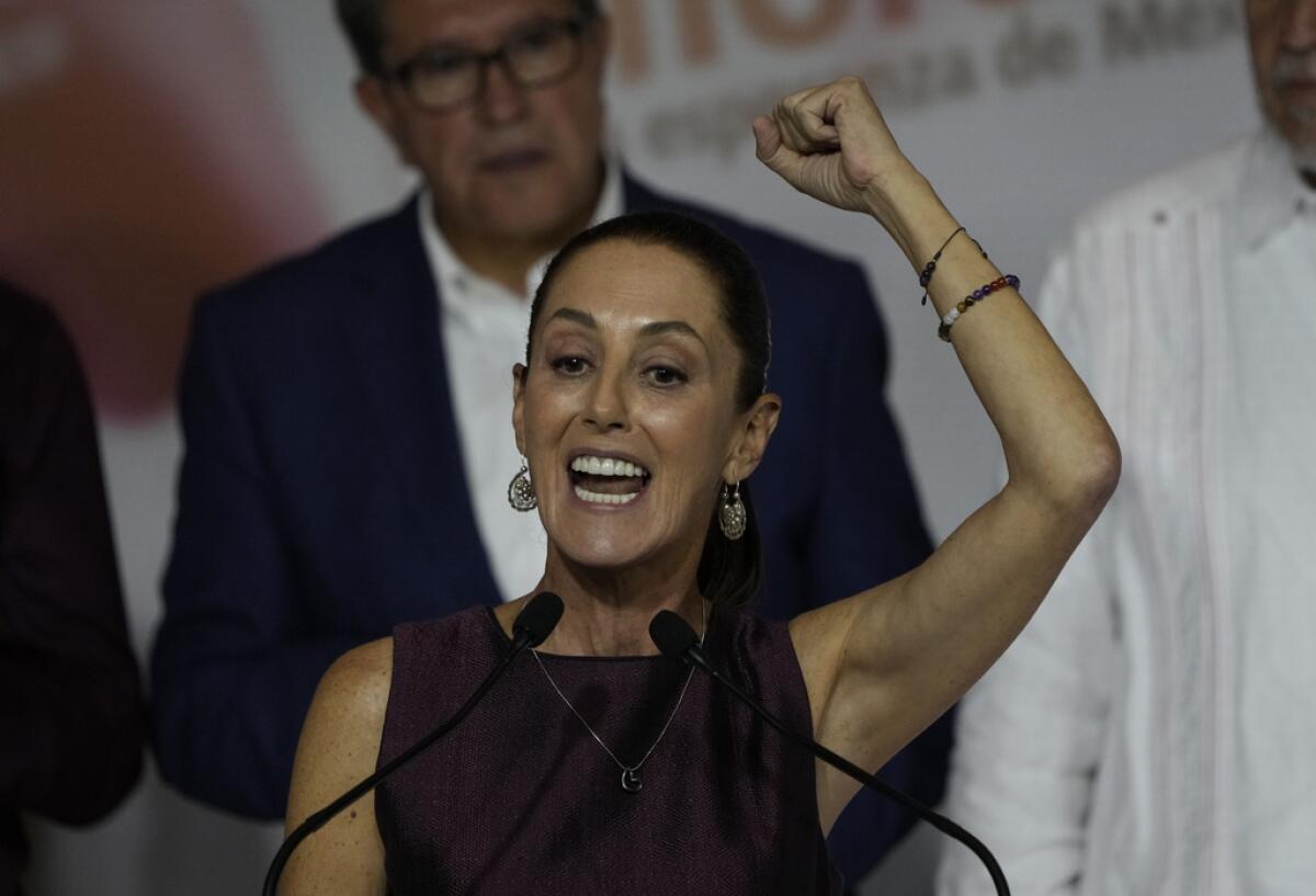 La presidenta Claudia Sheinbaum hace un gesto a la multitud durante un evento para conmemorar