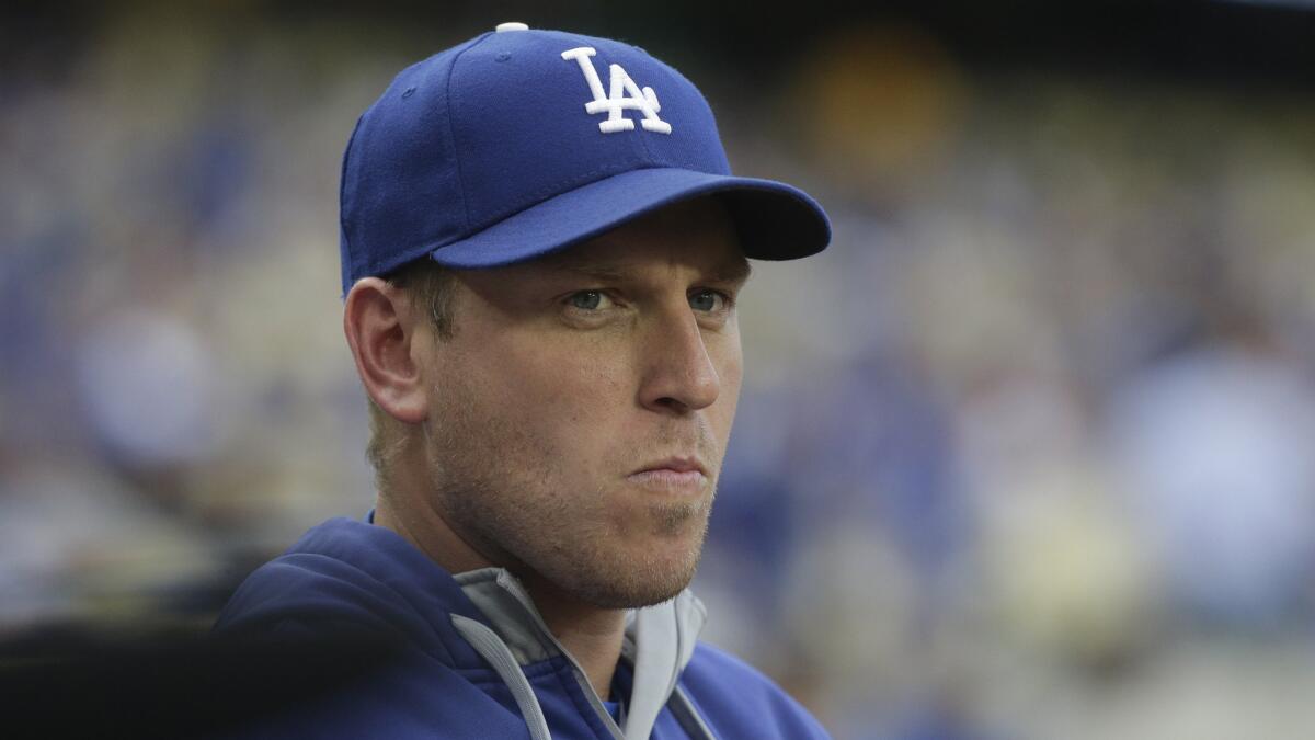 Dodgers catcher A.J. Ellis looks on from the dugout before a game against the Arizona Diamondbacks on June 9.